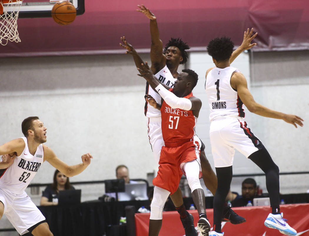 Houston Rockets' Deng Adel (57) takes a shot under pressure from Portland Trail Blazers' Nassir ...