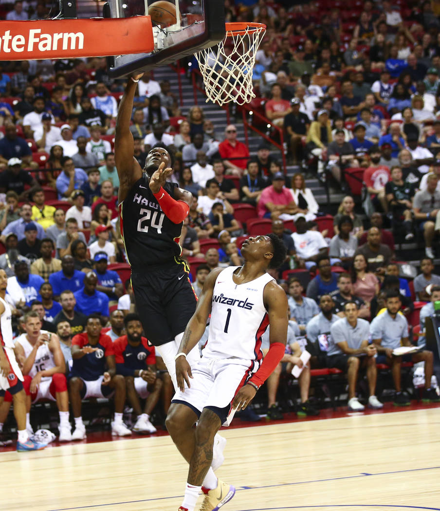 Atlanta Hawks' Bruno Fernando (24) goes to the basket past Washington Wizards' Admiral Schofiel ...
