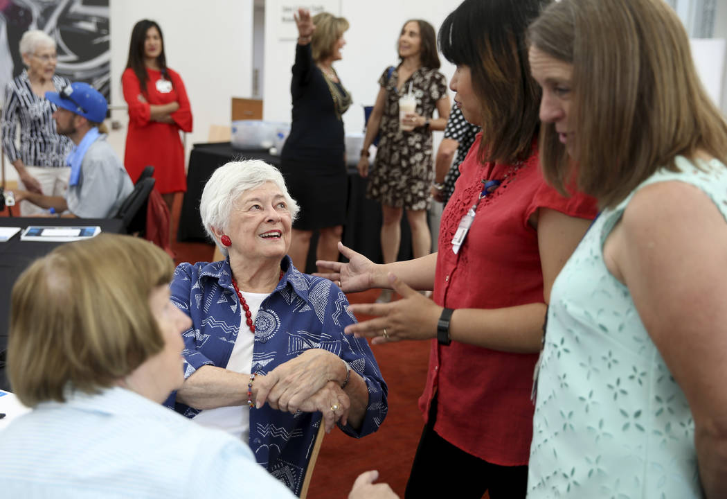 Longtime volunteers Cam Camburn, from left, and Barbara Ciocca, of Las Vegas, visit with Volunt ...