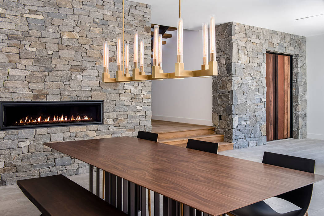 The dining room features a fireplace. (Jewel Homes)
