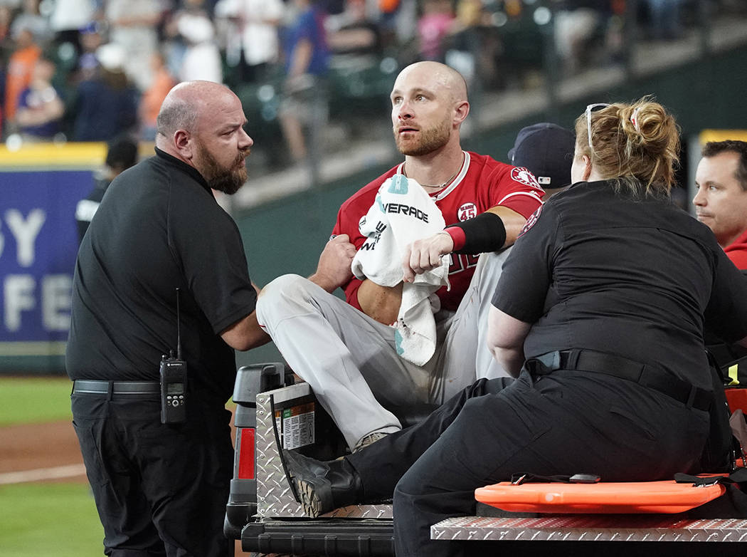 Los Angeles Angels' Jonathan Lucroy, center, is carted off the field after colliding with Houst ...