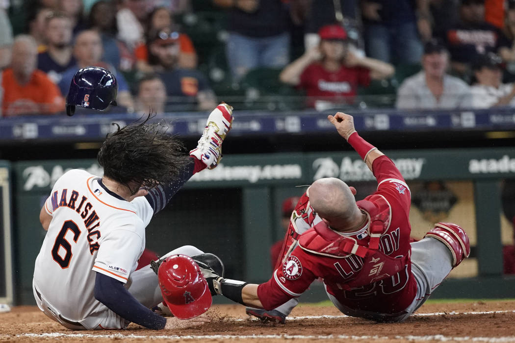 Houston Astros' Jake Marisnick, (6) collides Los Angeles Angels catcher Jonathan Lucroy (20) wh ...