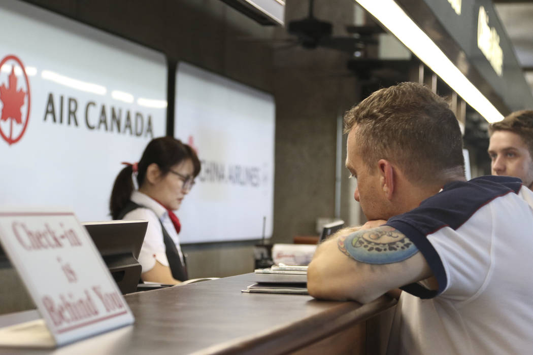 Andrew Szucs, right, who was on the Air Canada flight that made an emergency landing, waits for ...