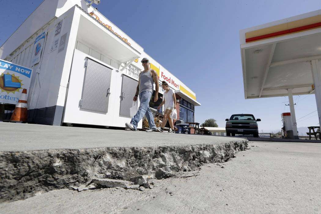 FILE - This July 6, 2019 photo shows crack in a gas station's driveway in the aftermath of an e ...