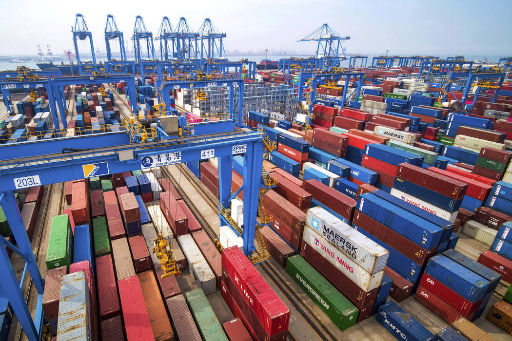 In a Tuesday, May 14, 2019, photo, containers are piled up at a port in Qingdao in east China's ...