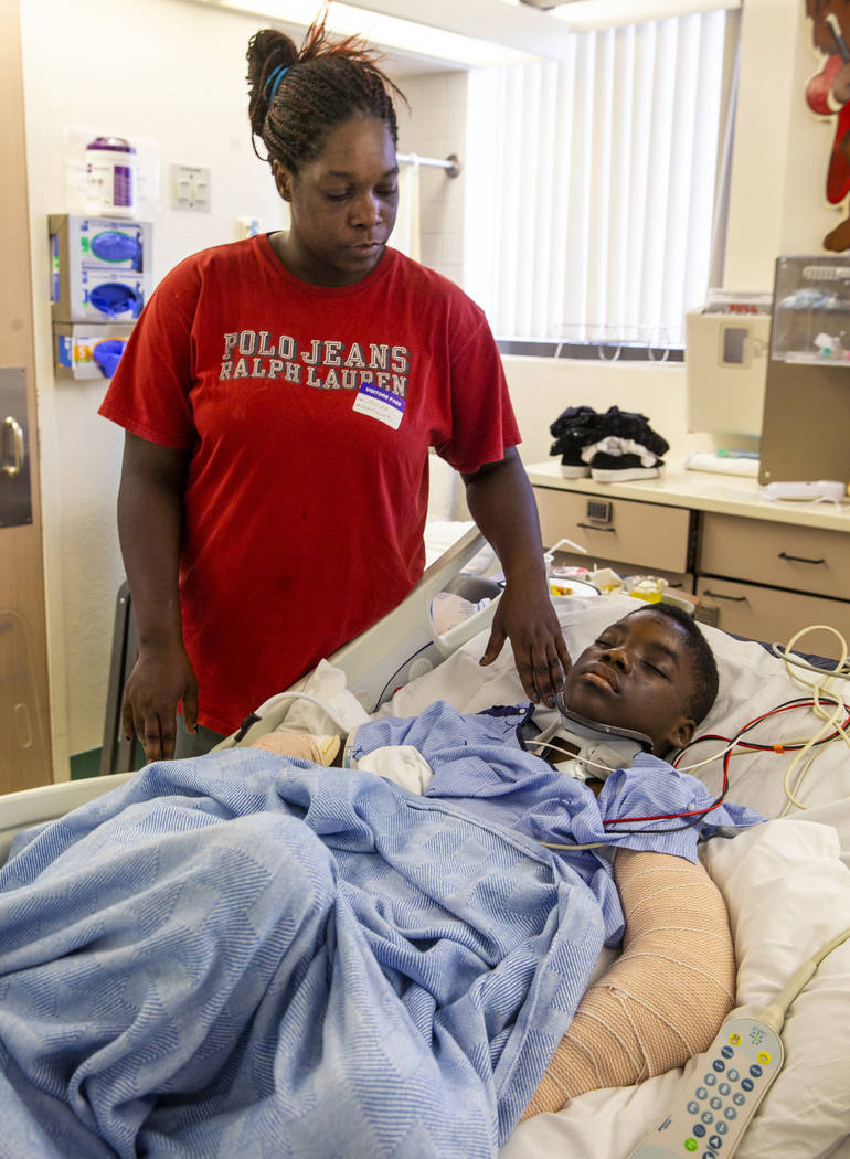 Thylicia McKnight, above, checks on her son Lennie Modica, 9, who is in recovery in the pediatr ...