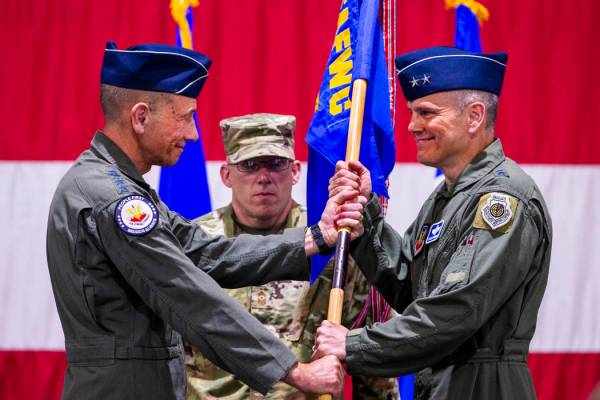 Gen. Mike Holmes, Commander of Air Combat Command, left, hands over the command flag to Maj.Gen ...