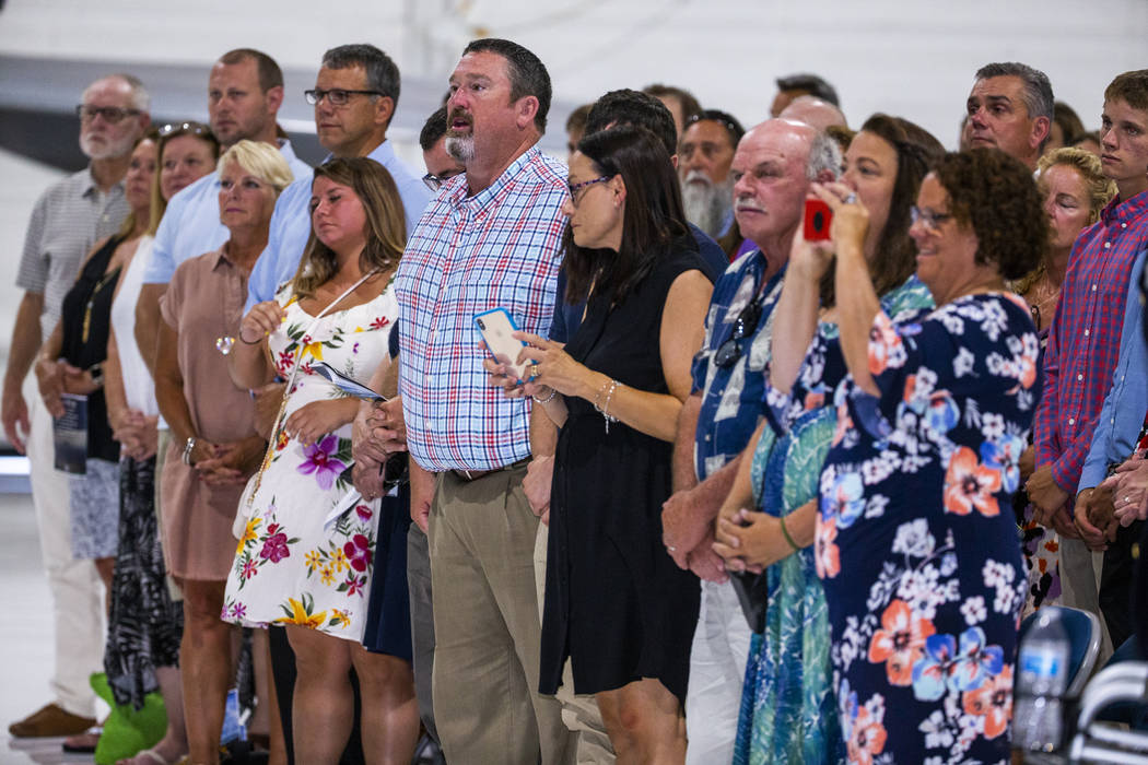 Family, friends and invited guests stand during the Assumption of Command Ceremony for Maj. Gen ...