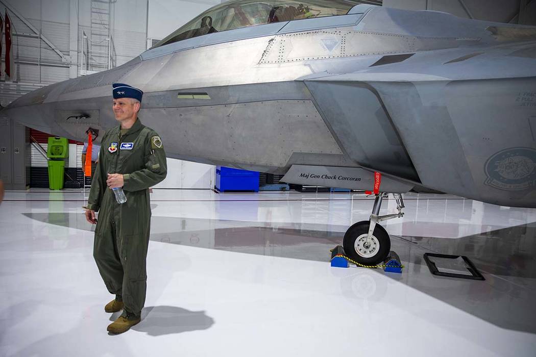 Maj. Gen. Charles Corcoran stands next to his fighter jet after the Naming of the Flagship is c ...