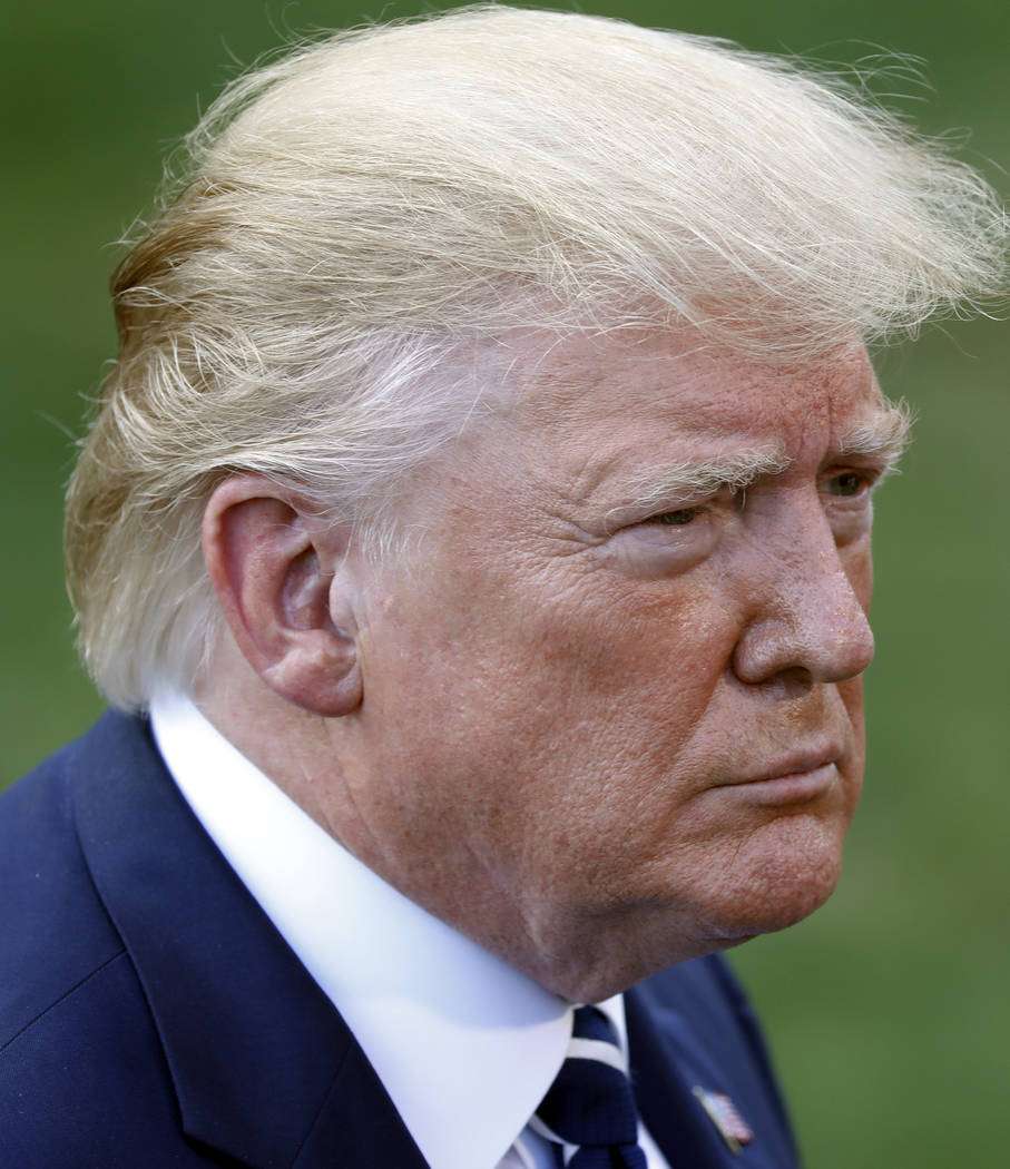 President Donald Trump speaks to members of the media before boarding Marine One helicopter on ...