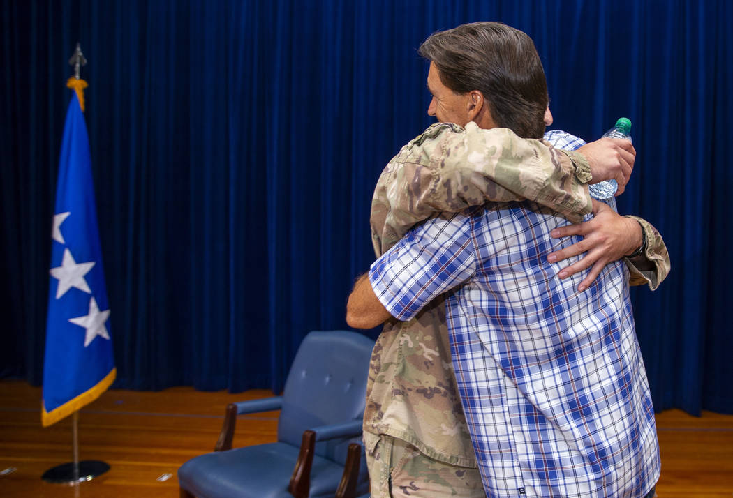 Staff Sgt. Kenneth DeLongchamp, left, hugs his father Ken at Nellis Air Force Base on Friday, J ...