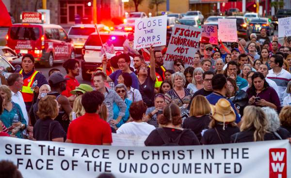 Advocates, activists and impacted persons gather for protest chants during Lights for Liberty: ...