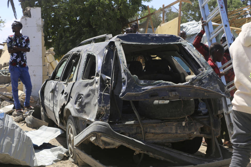 A view of a car destroyed during an attack at the Asasey Hotel, in Kismayo, Somalia, Saturday J ...