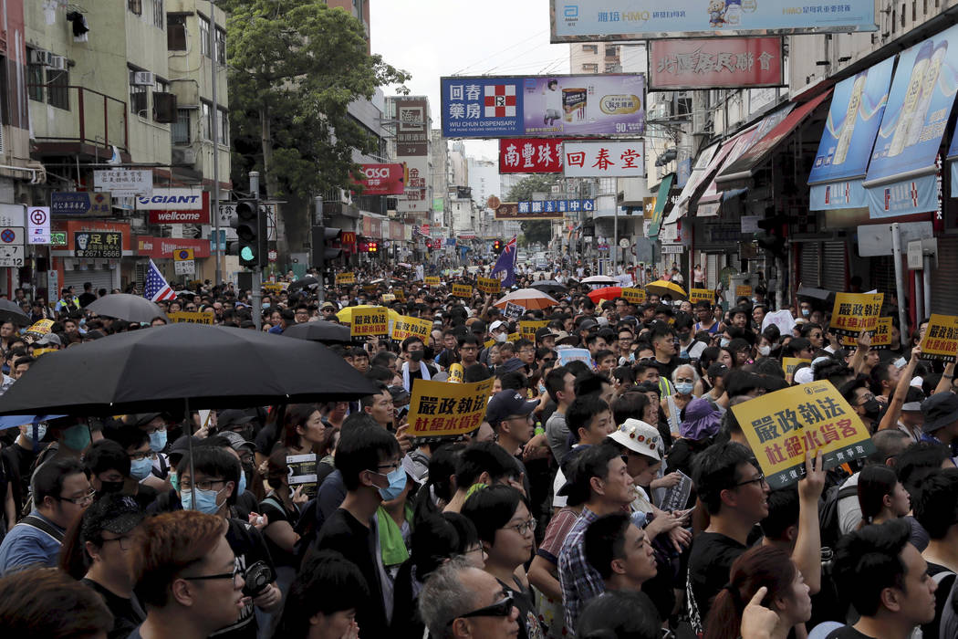 Protesters hold up words that read: "Strict enforcing of law against smugglers of grey goo ...