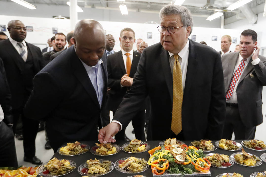 Attorney General William Barr, right, and Sen, Tim Scott, R-S.C., sample food prepared by an in ...