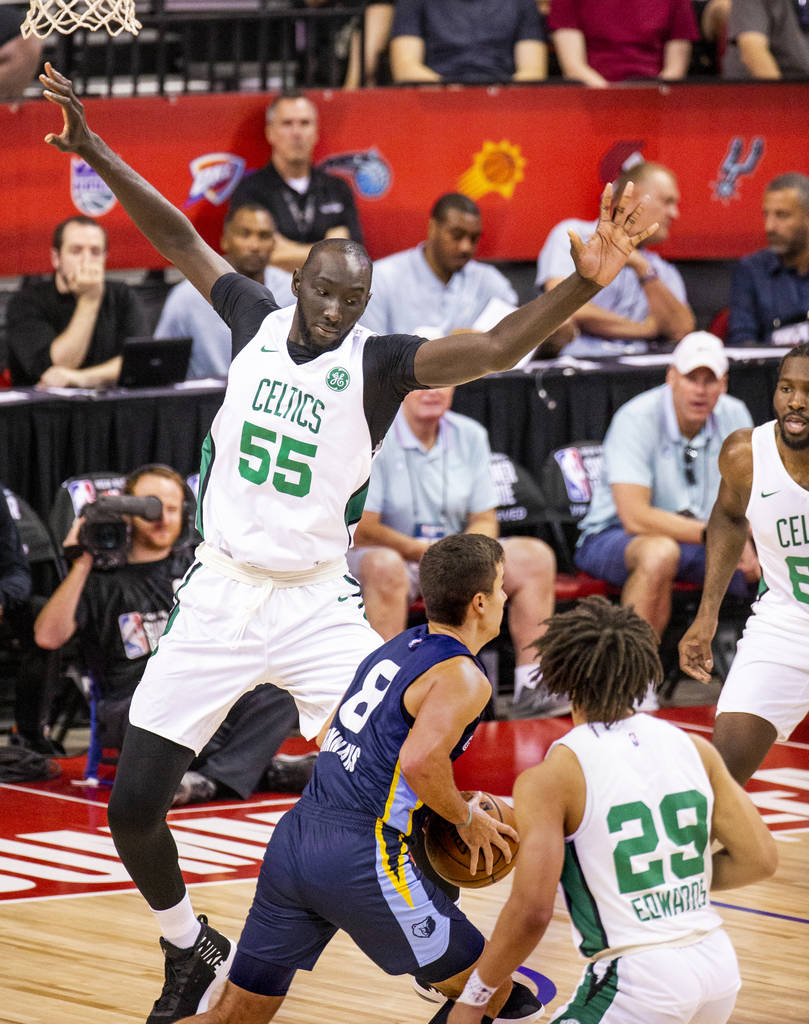 Boston Celtics center Tacko Fall defends the lane from Memphis Grizzlies guard Dusty Hannahs fo ...