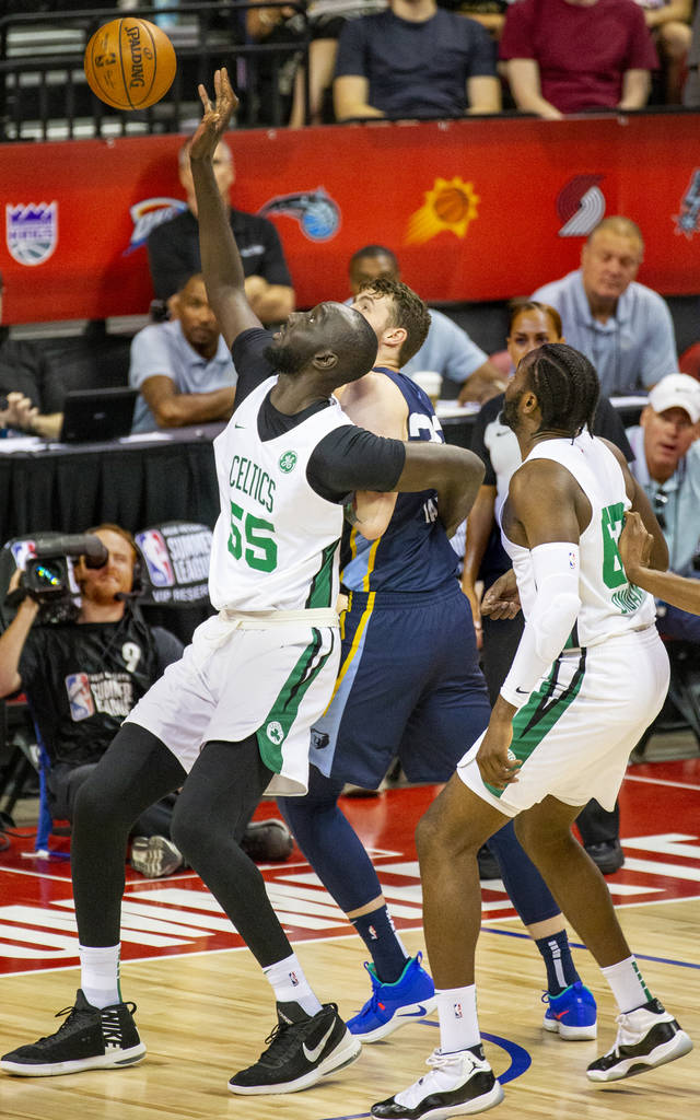 Boston Celtics center Tacko Fall, left, battles for a rebound over Memphis Grizzlies center Be ...