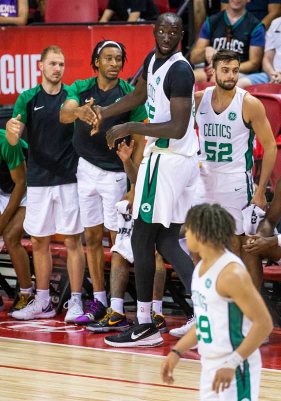 Boston Celtics center Tacko Fall, center, is congratulated by teammates after good play versus ...