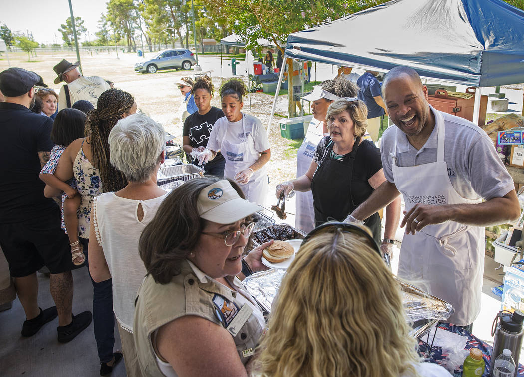 Nevada Attorney General Aaron Ford, top/right, greets guests during the 5th Annual Community BB ...