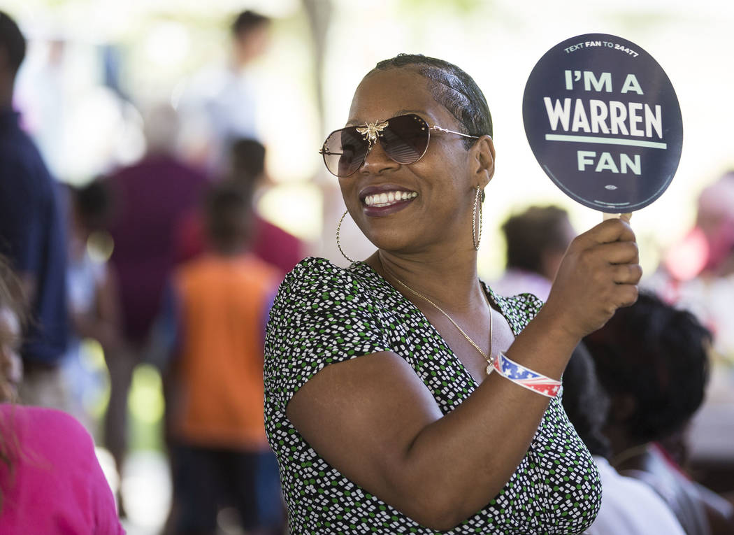 Lesha Lucas holds a sign for democratic presidential candidate Sen. Elizabeth Warren, D-Mass., ...