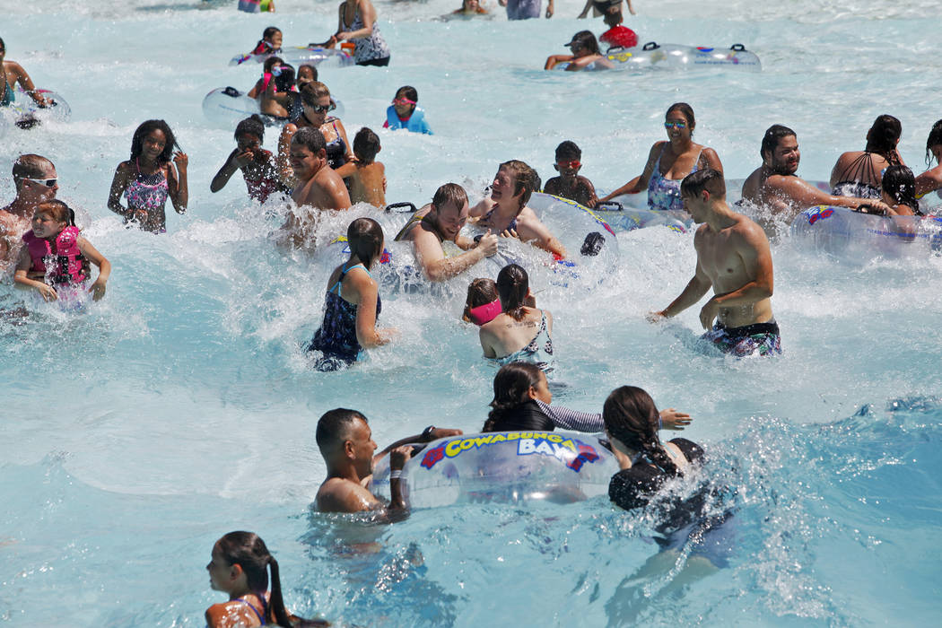 Revelers enjoy the Surf-A-Rama Wave Pool at Cowabunga Bay Water Park in Henderson, Sunday, July ...