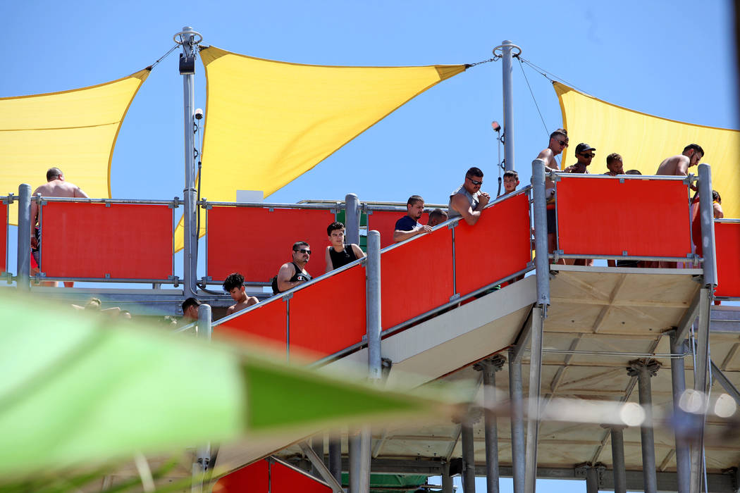 Guests wait in line for the Wild Surf slide at Cowabunga Bay water park in Henderson, Sunday, J ...