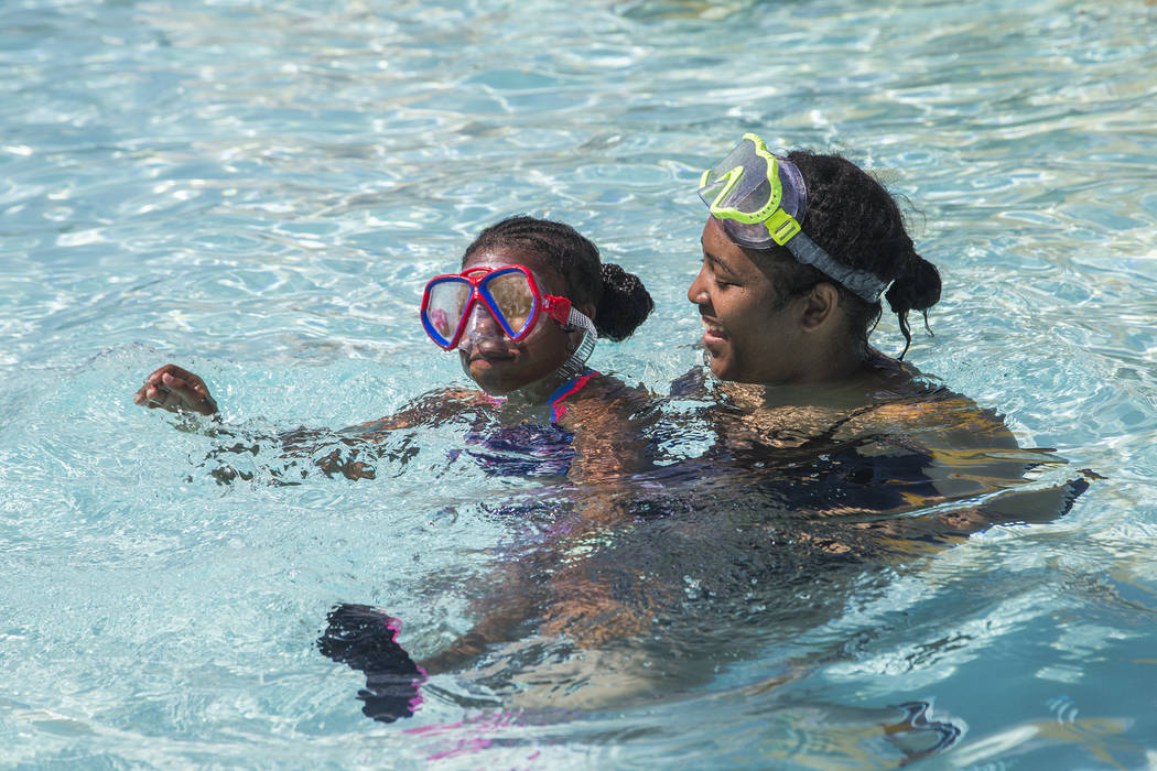 Tamia Boston, 17, holds her cousin Makaylia McNeill, 9, in a pool at Cowabunga Bay water park i ...
