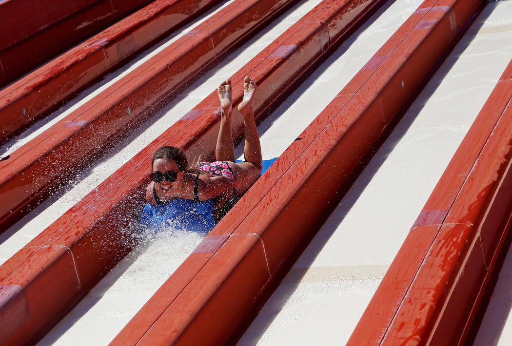 A guest enjoys the Surfing' USA slide at Cowabunga Bay water park in Henderson, Sunday, July 14 ...