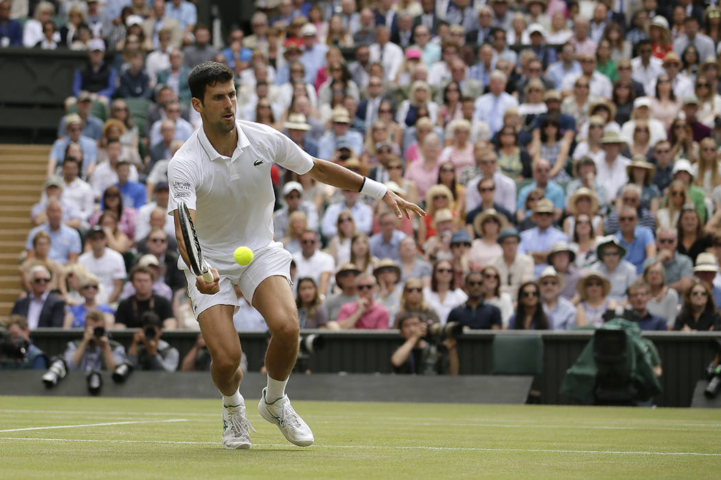 Serbia's Novak Djokovic returns the ball to Switzerland's Roger Federer during the men's single ...