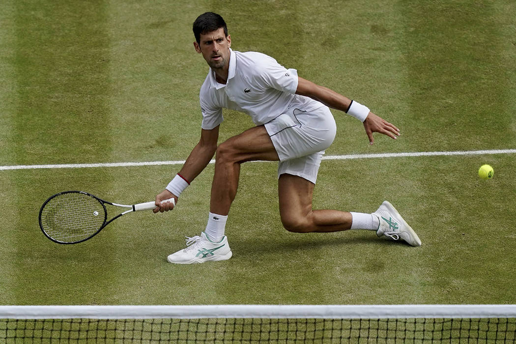 Serbia's Novak Djokovic plays a return to Switzerland's Roger Federer during the men's singles ...