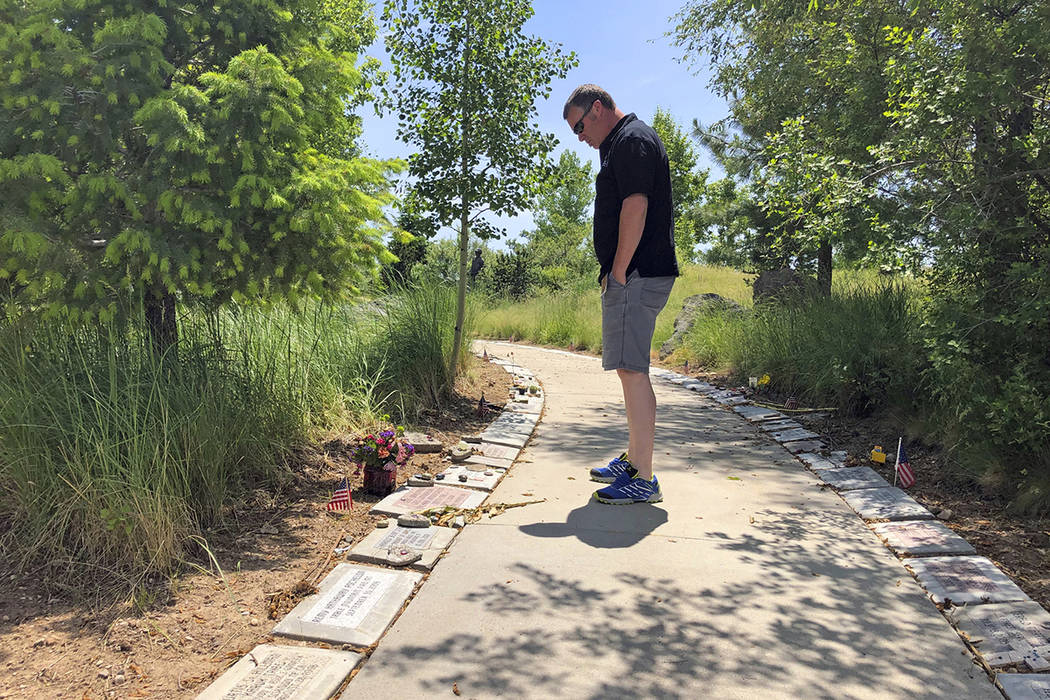 In his June 3, 2019 photo, Bill Arsenault of the Idaho Falls Fire Department looks at memorial ...