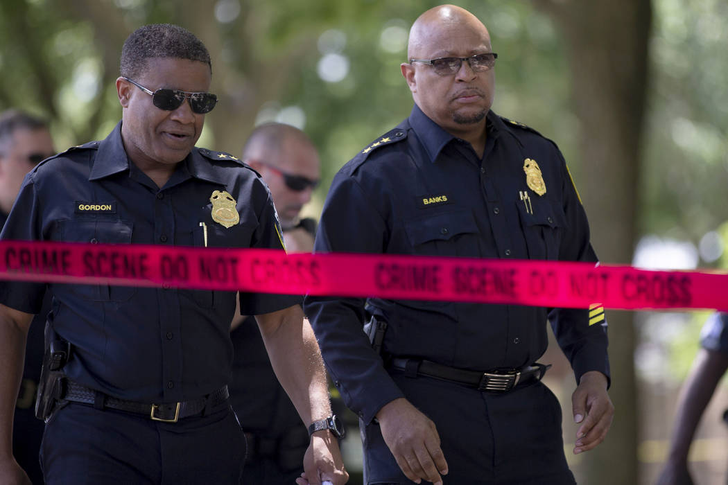 Milwaukee Police officers approach the press in the 1600 north block of 26th Street in Milwauke ...