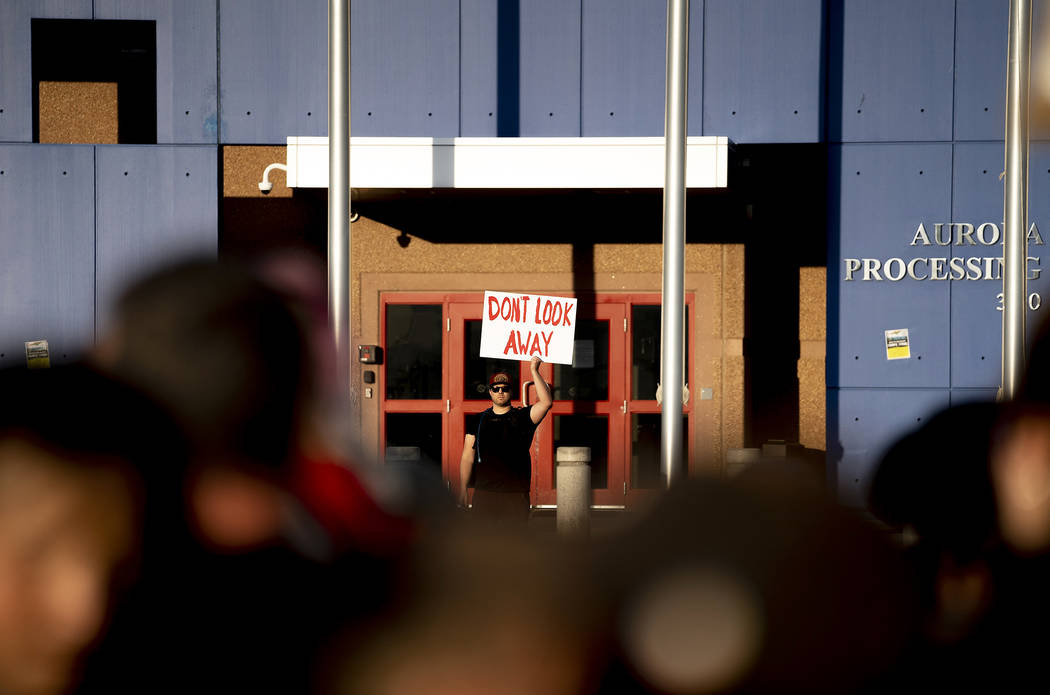 In this Friday, July 12, 2019, photo, a sole protester stands beyond the threshold and on GEO p ...