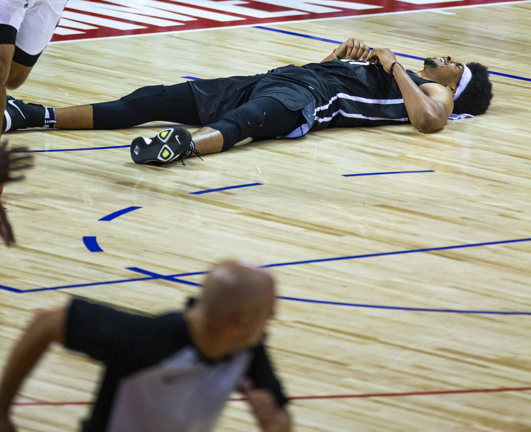 Brooklyn Nets center Jarrett Allen lays on the court after a collision under the basket and har ...