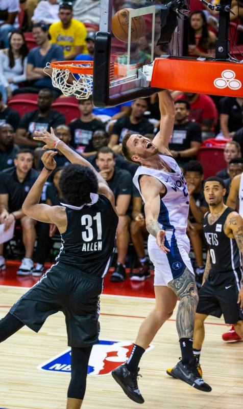 Brooklyn Nets center Jarrett Allen, left, is unable to defend a shot by Minnesota Timberwolves ...