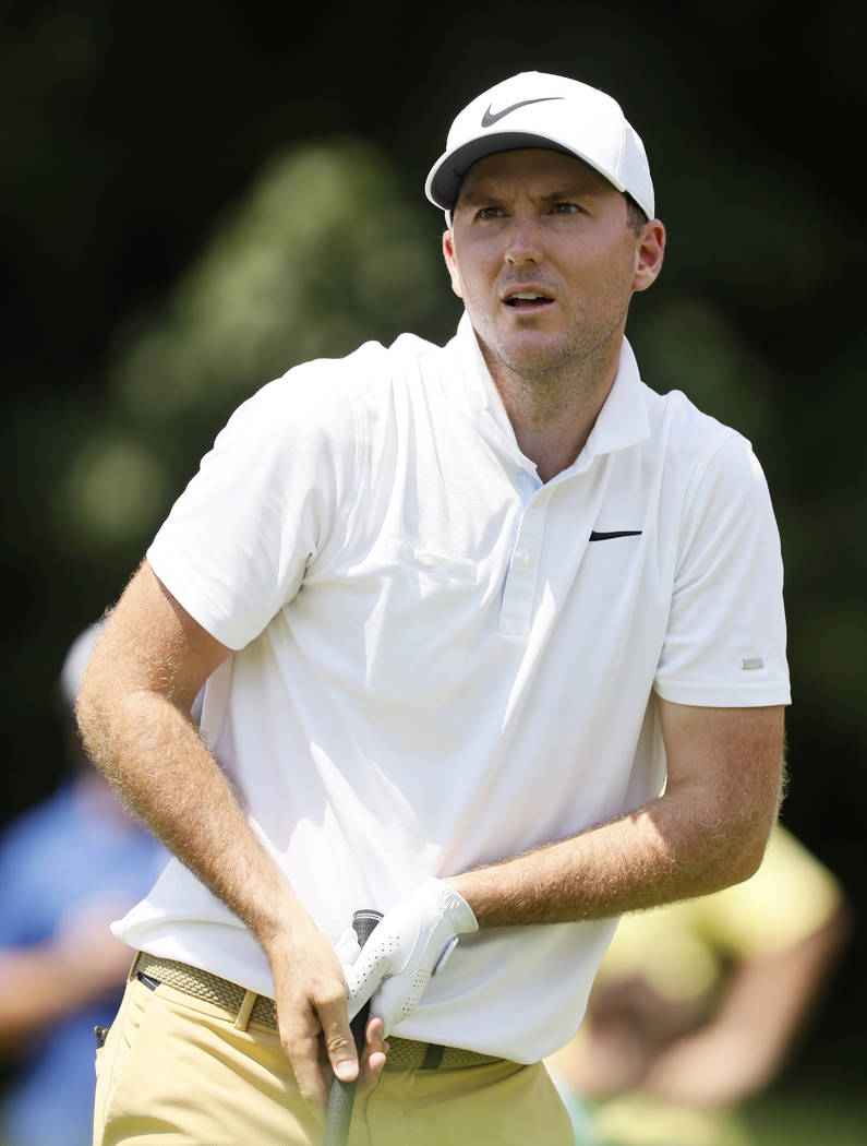 Russell Henley watches his shot off the 18th tee during the final round of the John Deere Class ...