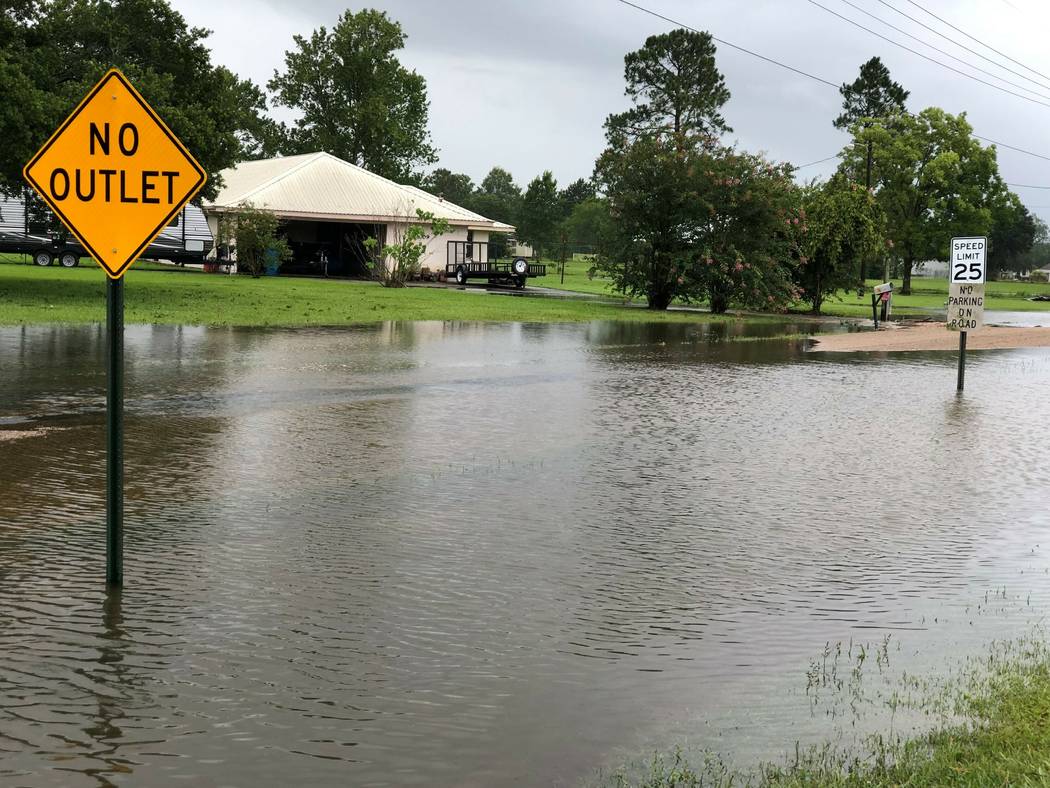 Floodwater pools near homes in St. Martinville, La., Sunday, July 14, 2019, in the aftermath of ...