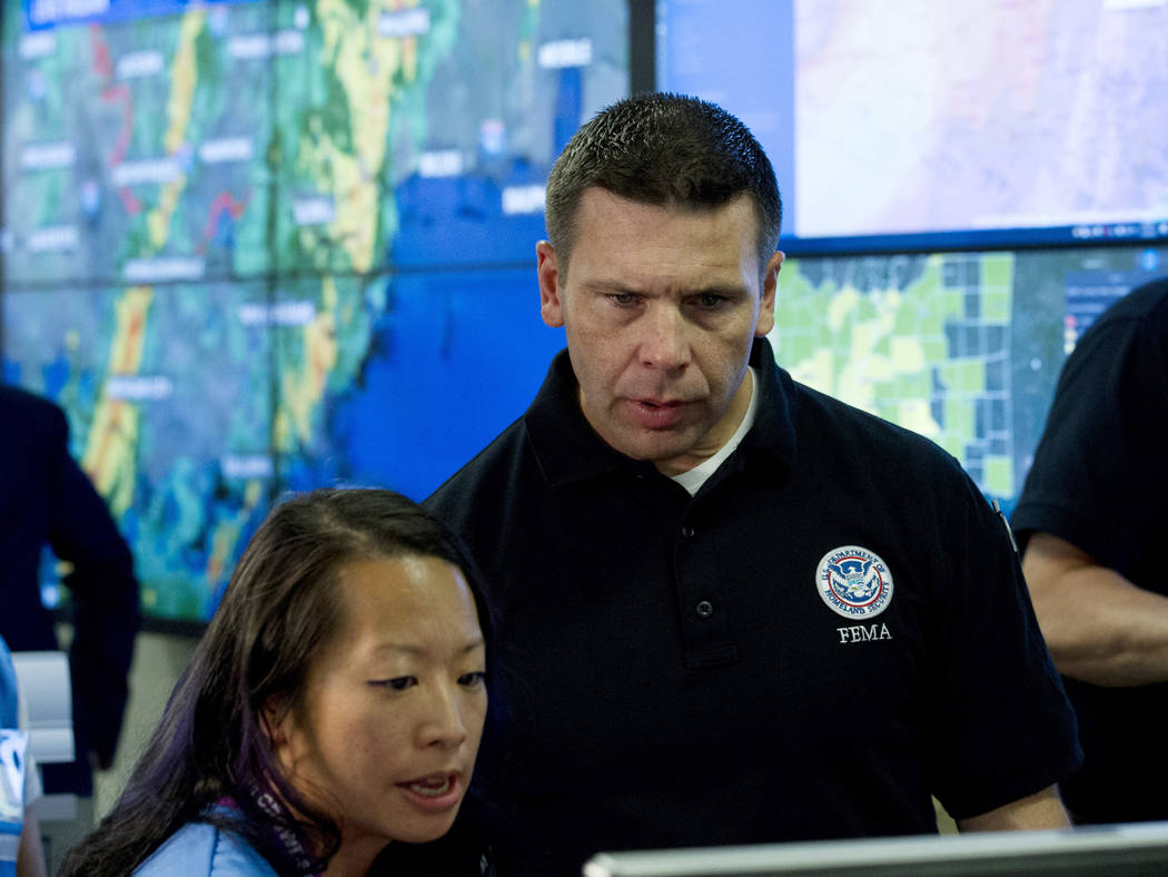 Acting Homeland Security Secretary Kevin McAleenan speaks with FEMA personnel, as he gets infor ...