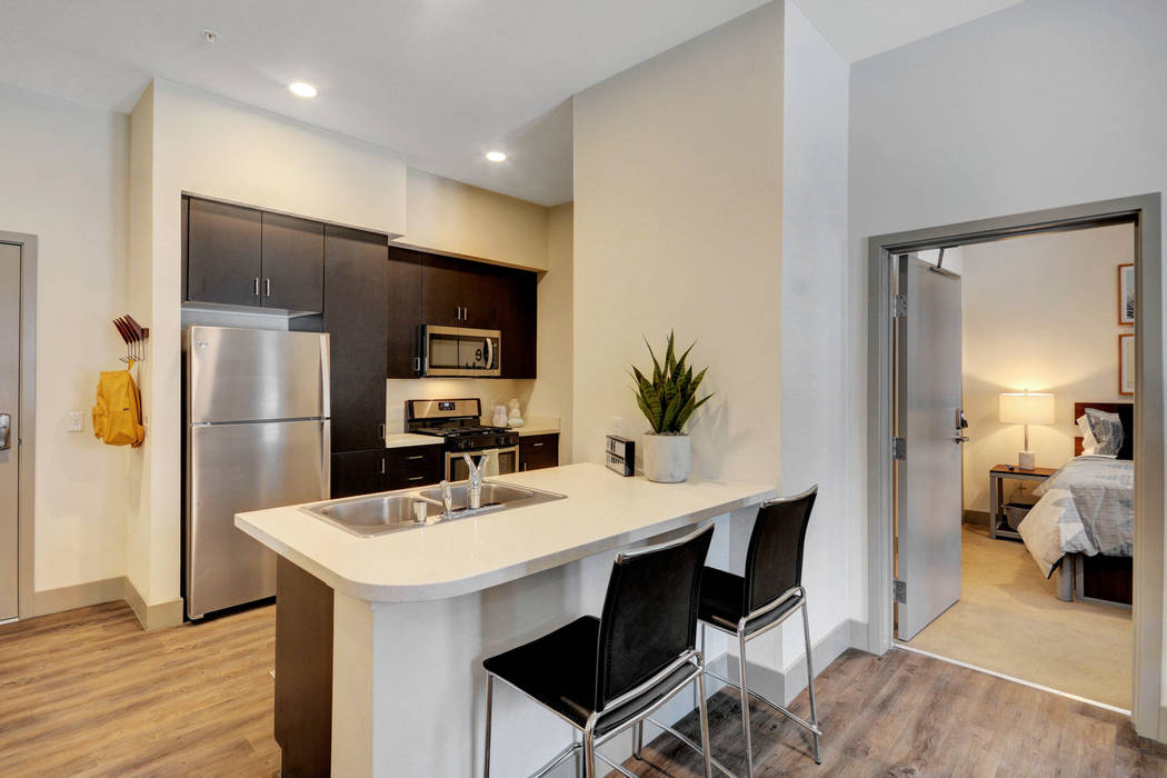 Each apartment includes a living room, television and entertainment-style kitchen with stainles ...