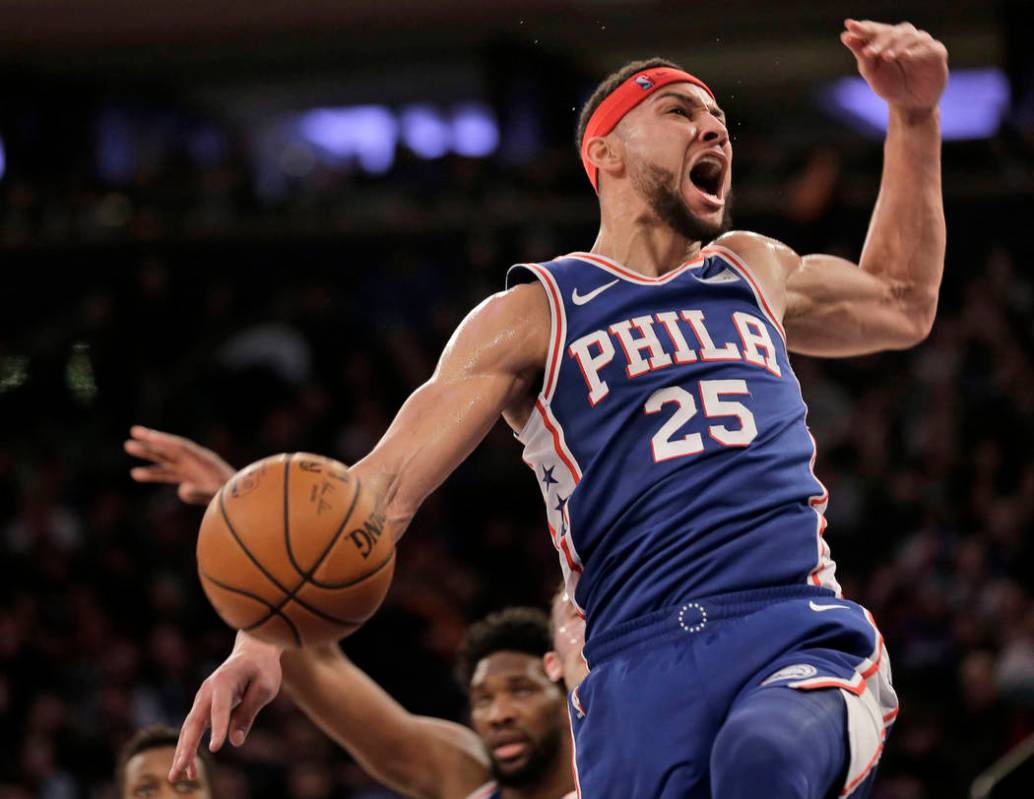 Philadelphia 76ers' Ben Simmons reacts after dunking during the first half of an NBA basketball ...