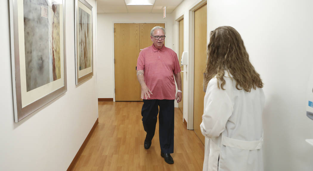 In this July 9, 2019 photo, Dr. Jori Fleisher, neurologist, examines Thomas Doyle, 66, at the R ...