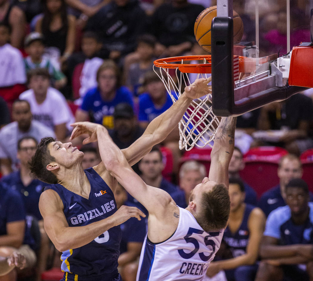 Memphis Grizzlies guard Grayson Allen, left, battles for the basket with Minnesota Timberwolves ...