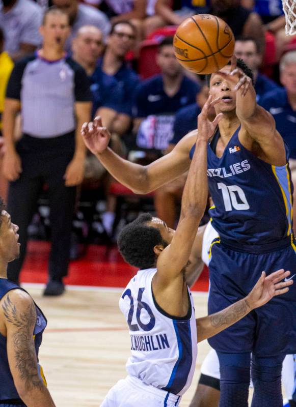 Memphis Grizzlies forward Ivan Rabb, top, blocks a shot from Minnesota Timberwolves guard Jorda ...