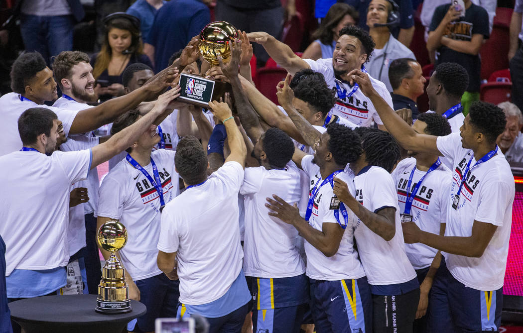 Memphis Grizzlies' players hoist and touch the winning trophy after defeating the Minnesota Tim ...