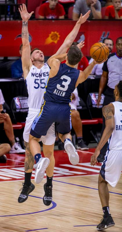 Minnesota Timberwolves forward Mitch Creek, left, defends the basket as Memphis Grizzlies guard ...