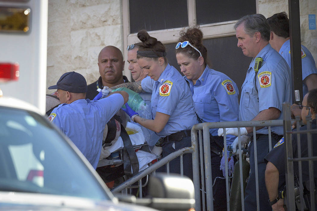 Baltimore Fire Dept. paramedics transport a patient from the Man Alive drug treatment center on ...