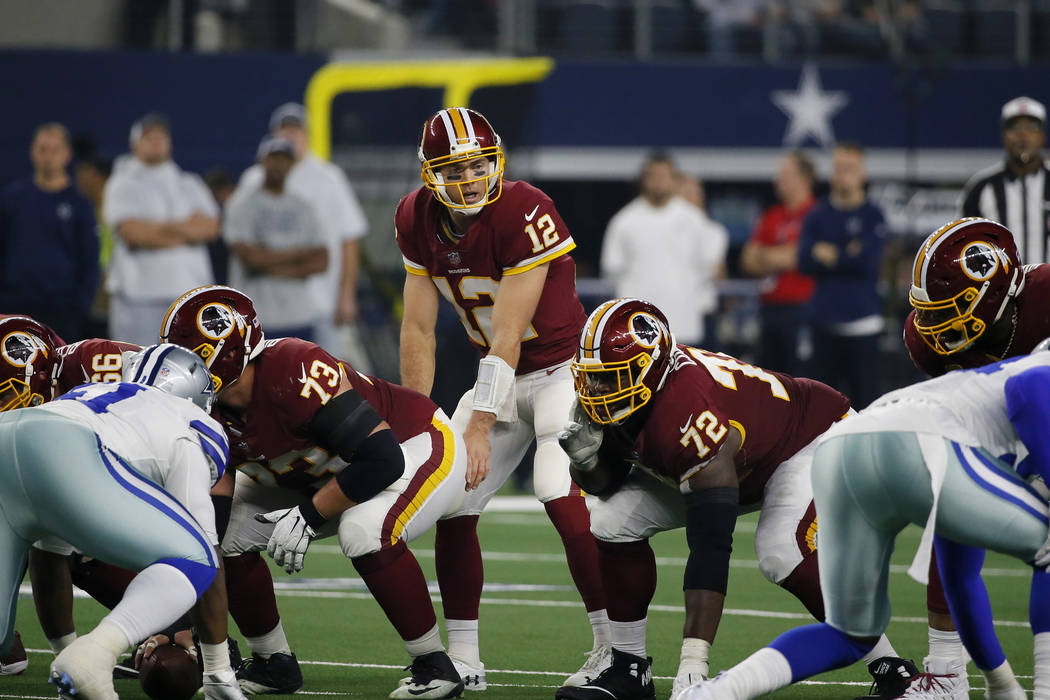 Washington Redskins quarterback Colt McCoy (12) prepares for the snap along with guard Jonathan ...