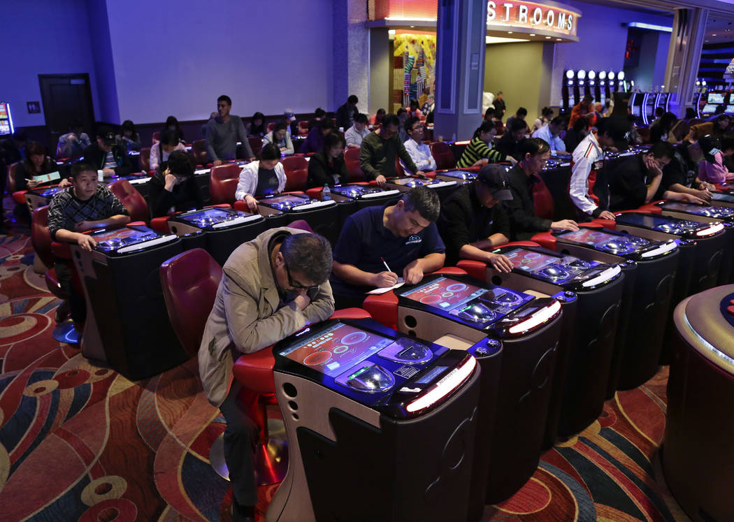 Visitors to the Resorts World Casino at the Aqueduct racetrack play electronic baccarat games i ...