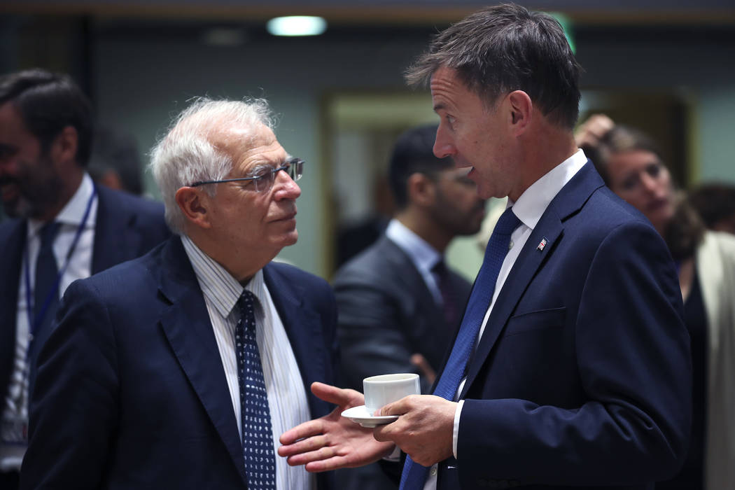 Britain's Foreign Secretary Jeremy Hunt, right, talks to his Spanish counterpart Josep Borrell ...