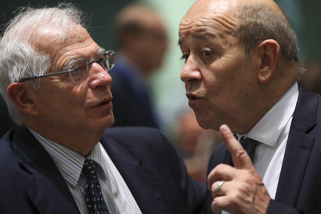 Spain's Foreign Minister Josep Borrell, left, talks to his French counterpart Jean-Yves Le Dria ...